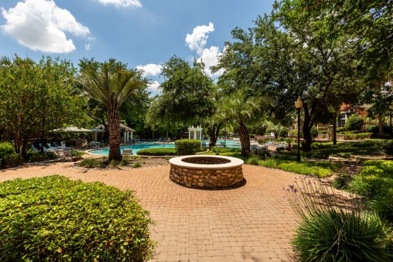 Brick courtyard with circular stone firepit.